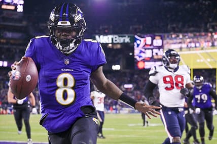 Jan 20, 2024; Baltimore, MD, USA; Baltimore Ravens quarterback Lamar Jackson (8) reacts after running past for Houston Texans defensive tackle Sheldon Rankins (98) for a touchdown during the fourth quarter in a 2024 AFC divisional round game at M&T Bank Stadium. Mandatory Credit: Tommy Gilligan-USA TODAY Sports