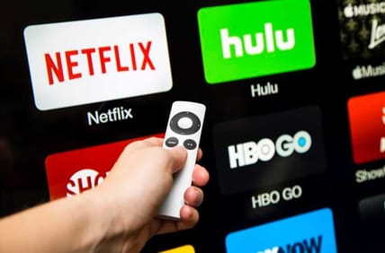 Man Choosing Between Streaming Providers On Smart TV With Remote